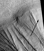Martian gullies and remnant snow bank (arrow)  (NASA/JPL/MSSS/P. Christensen)