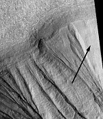 Martian gullies and remnant snow bank (arrow) (NASA/JPL/MSSS/P. Christensen)