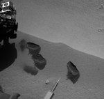 MSL Curiosity scooping Martian soil (NASA/JPL)